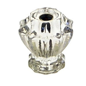 May include: A clear, decorative glass object with a bulbous shape and a flared base. The top has a small opening, and the sides feature a textured, ridged design. The glass reflects light, creating a shimmering effect. This item is likely a decorative piece or a small container.