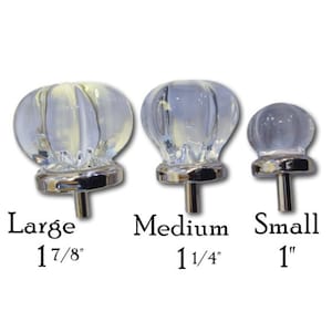May include: Three clear glass cabinet knobs with silver bases. The knobs are in three sizes: large (1 7/8 inches), medium (1 1/4 inches), and small (1 inch).