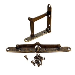 May include: Two antique brass folding hinges with a set of screws. The hinges are designed to fold flat when not in use.