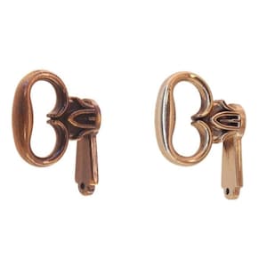 May include: Two antique keys, one with a copper finish and one with a silver finish. Both keys have an ornate design with a heart-shaped bow.