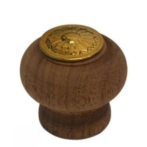 May include: A wooden knob with a gold metal top featuring a decorative design. The knob is brown and has a smooth, rounded shape.