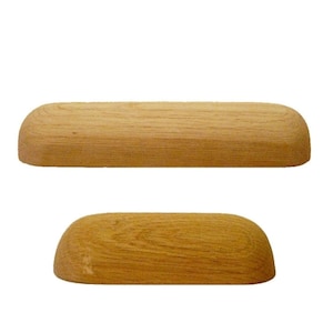 May include: Two wooden drawer pulls with a rounded, dome-shaped top. The pulls are made of light brown wood with a natural grain.