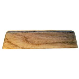 May include: A rectangular wooden object with a light brown color and visible wood grain. The object has a slightly curved top edge and angled ends. The wood appears to be a hardwood, possibly oak, and is unfinished.