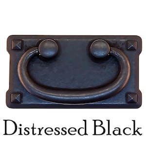 May include: Distressed black metal drawer pull with a rectangular base and a rounded, D-shaped handle. The pull has decorative accents on the corners.