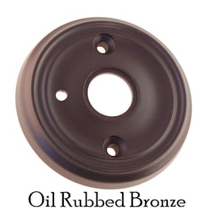 May include: Oil rubbed bronze door knob backplate with three screw holes.