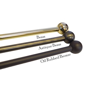May include: Three metal curtain rods with ball finials in brass, antique brass, and oil rubbed bronze finishes.