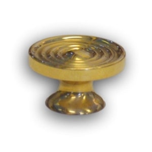 May include: A gold-toned cabinet knob with a circular, ridged top and a round base.