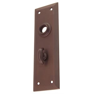 May include: A rectangular, dark brown, metal door plate with a rounded, decorative knob and a keyhole. The plate has a beveled edge and two small holes on each side.