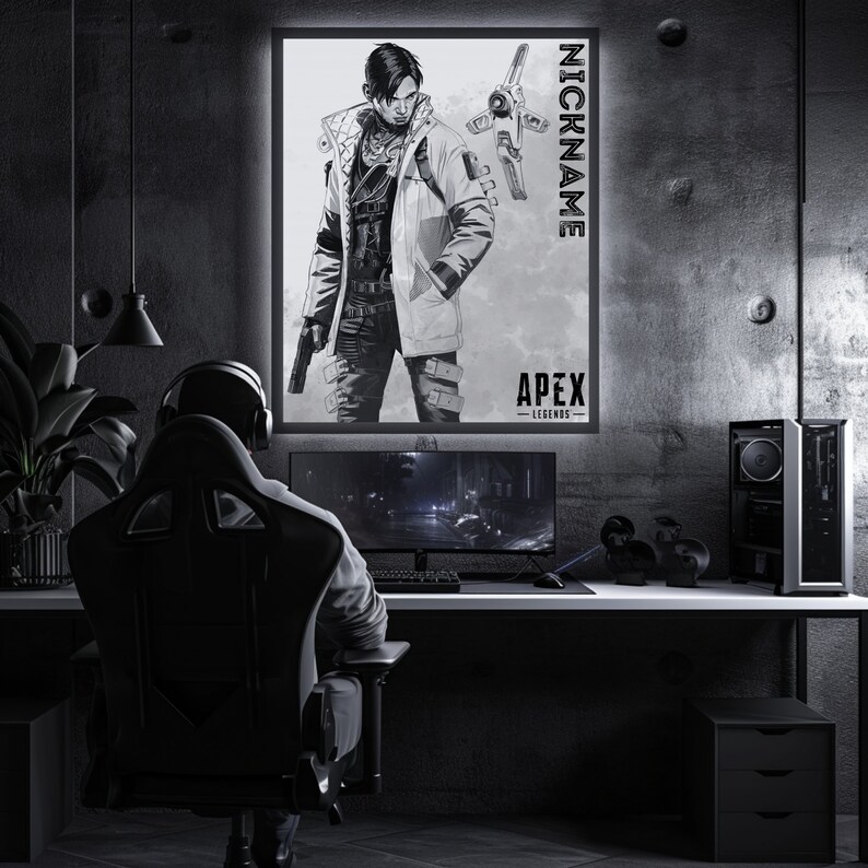 May include: A black and white illustration of a video game character from Apex Legends. The character is wearing a jacket and holding a gun. The image is framed and hanging on a wall in a dark room. The text "NICKNAME" and "APEX LEGENDS" is visible on the image.