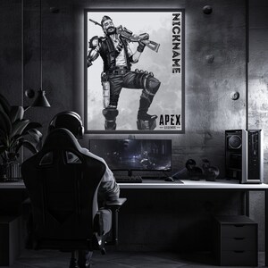May include: A black and white illustration of a video game character from Apex Legends. The character is standing with a weapon in their hand. The image is framed and hanging on a wall in a dark room. The text "NICKNAME" and "APEX LEGENDS" is visible on the image.