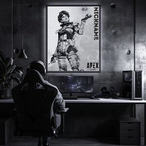 May include: A black and white illustration of a female video game character from Apex Legends. The character is holding a weapon and is standing in a fighting pose. The image is framed and hanging on a wall in a gaming room. The text "NICKNAME" and "APEX LEGENDS" is visible on the image.