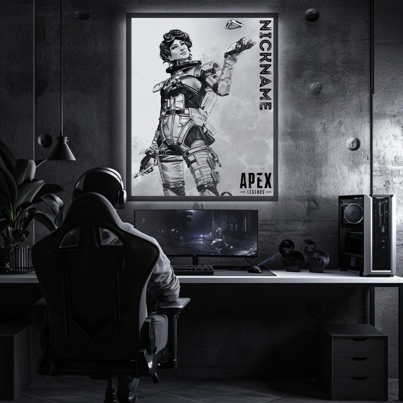 May include: A black and white illustration of a female video game character from Apex Legends. The character is holding a weapon and is standing in a fighting pose. The image is framed and hanging on a wall in a gaming room. The text "NICKNAME" and "APEX LEGENDS" is visible on the image.