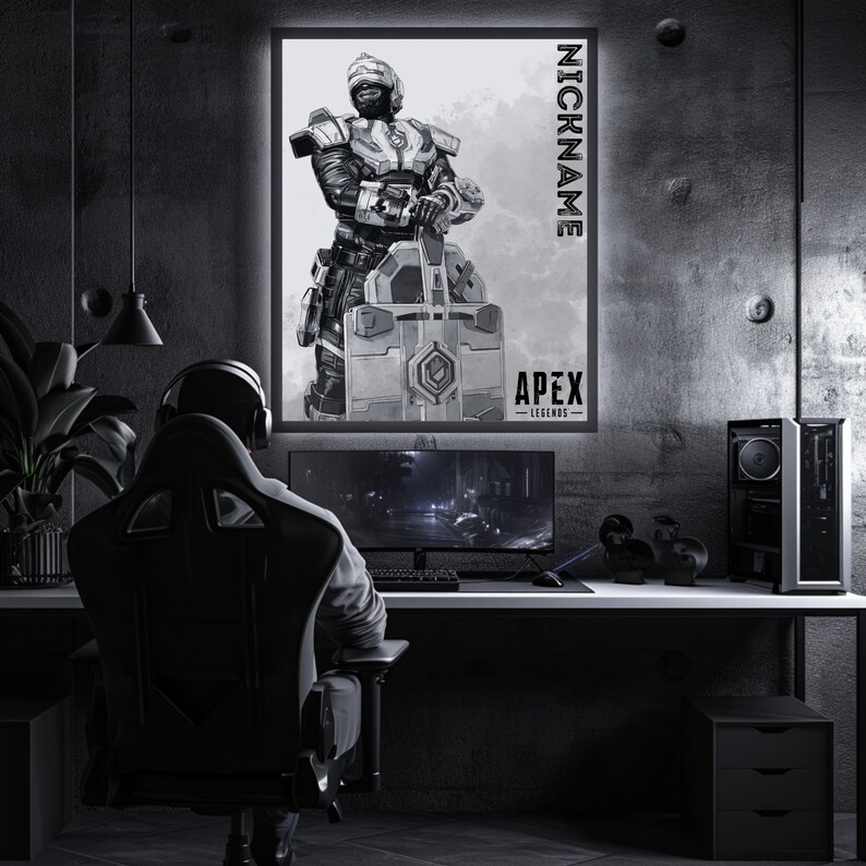 May include: A black and white illustration of a video game character from Apex Legends. The character is holding a large weapon and is wearing a helmet and armour. The image is framed and hanging on a wall in a dark room. The text "NICKNAME" and "APEX LEGENDS" is visible on the image.