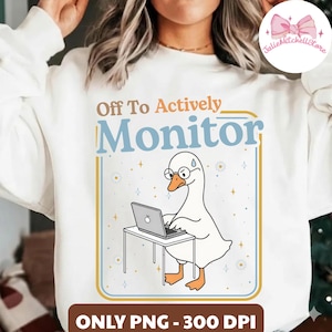 May include: White sweatshirt with a graphic of a goose wearing glasses and working on a laptop. The text reads "Off To Actively Monitor" in a blue and brown font. The image is framed with a blue and gold border.