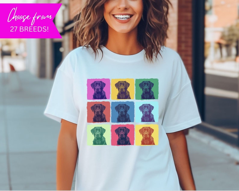 May include: A white t-shirt with a pop art design featuring a black labrador retriever in nine different colored squares.