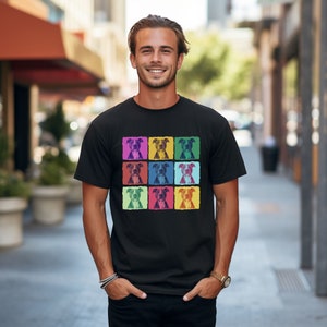 May include: A black t-shirt with a colorful pop art design featuring a repeated image of a pit bull dog.