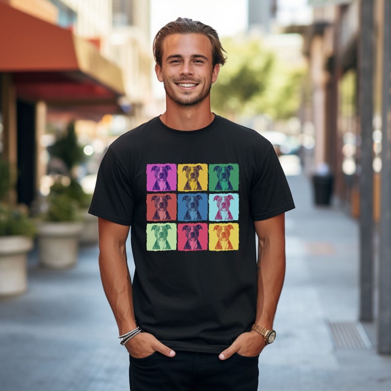 May include: A black t-shirt with a colorful pop art design featuring a repeated image of a pit bull dog.