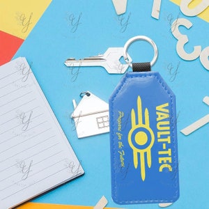 May include: Blue leather keychain with a yellow Vault-Tec logo and the text "Prepare for the Future".