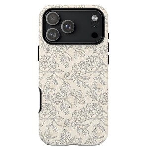 May include: A phone case with a floral design. The case features a cream-colored background with a repeating pattern of black line-drawn flowers and leaves. The case has a black camera module and a black card slot.