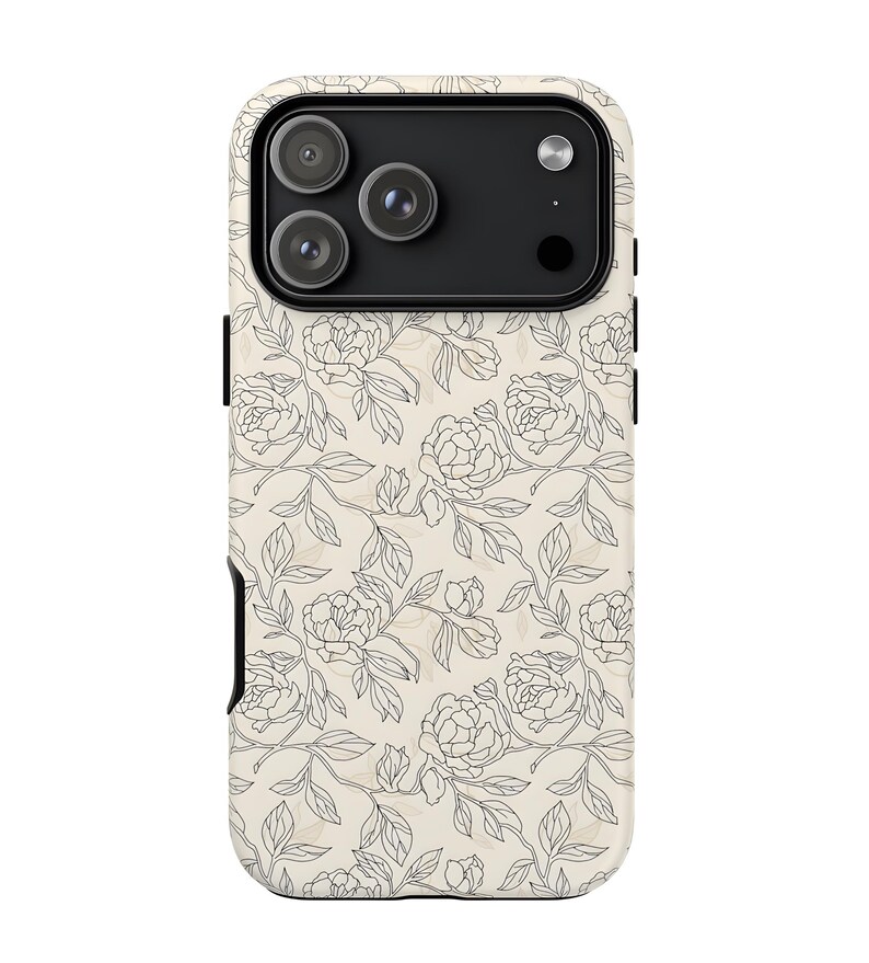 May include: A phone case with a floral design. The case features a cream-colored background with a repeating pattern of black line-drawn flowers and leaves. The case has a black camera module and a black card slot.