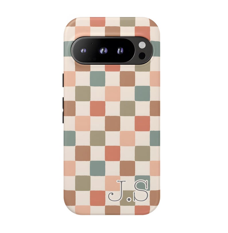 May include: A phone case with a checkerboard pattern in shades of brown, peach, green, and cream. The case has a camera cutout and the initials "J.S" at the bottom. The case is designed to fit a smartphone.