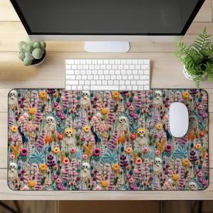 May include: A colourful mouse mat with a floral pattern featuring embroidered skeletons and flowers. The mouse mat is designed for use with a computer mouse.