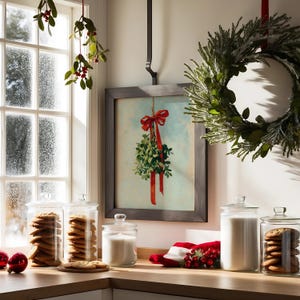 May include: A festive holiday scene featuring a framed mistletoe print with a red bow, a green wreath, and glass jars filled with cookies and milk. Red ornaments and a Santa hat add to the Christmas decor.