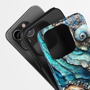 May include: A black phone case with a blue and green abstract design. The case has a cutout for the camera lens.