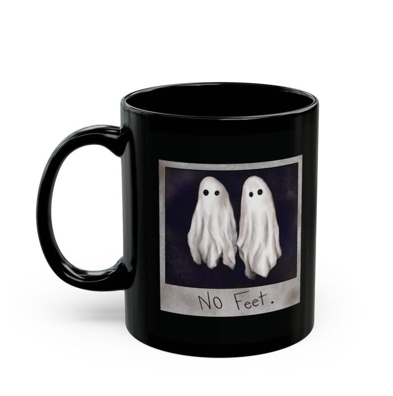 May include: Black coffee mug with a white ghost illustration and the text "No Feet."