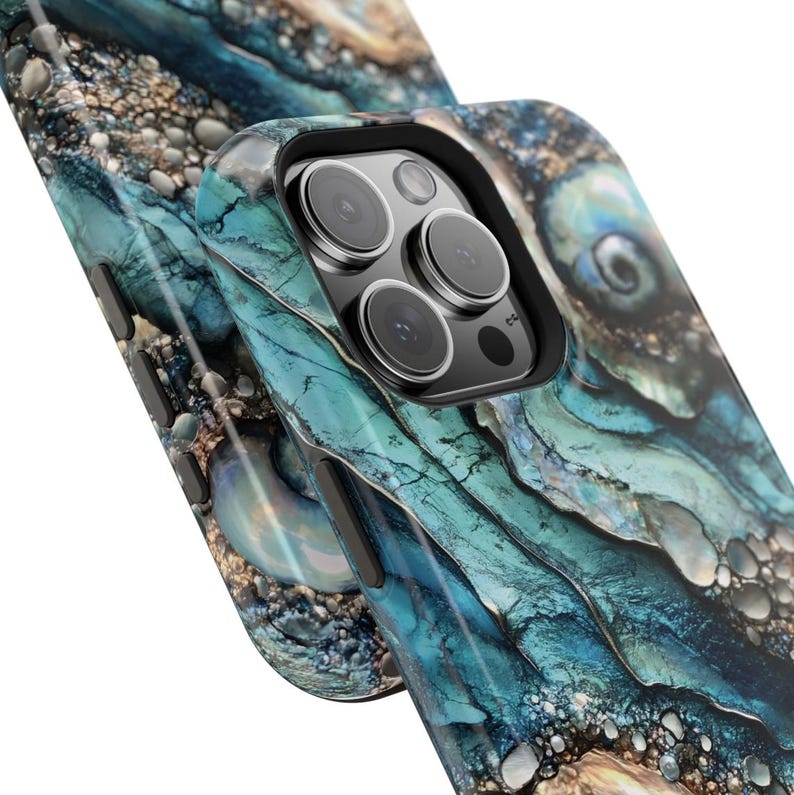 May include: A blue and gold marble phone case with a camera lens cutout. The case has a swirling pattern reminiscent of ocean waves.