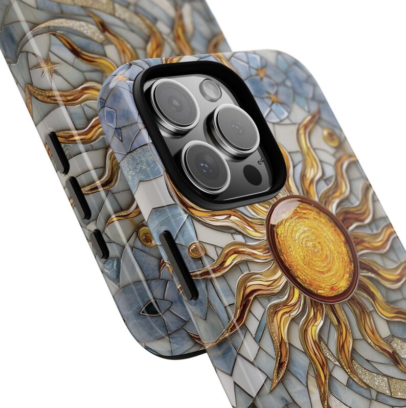 May include: A white phone case with a mosaic design featuring a sun with gold rays and blue and white geometric shapes.
