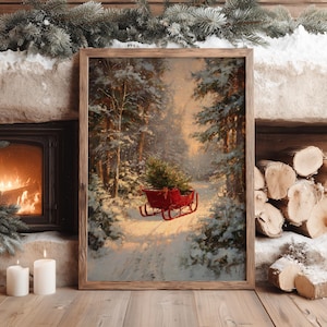 May include: A framed vertical wall art print depicting a snowy forest scene with a bright red sleigh carrying a small evergreen tree. The painting features tall pine trees covered in snow, soft golden light filtering through the woods, and a path.