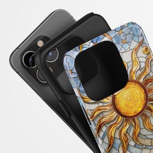 May include: A black phone case with a mosaic design featuring a gold sun and blue and white accents.