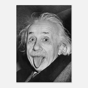 May include: A black and white portrait of an older individual with messy, thinning white hair, a prominent mustache, and a thick coat. The subject is looking directly forward with wide eyes and has their tongue extended outward in a playful expression.