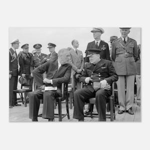 May include: A black and white historical photograph featuring Franklin D. Roosevelt and Winston Churchill seated in chairs, surrounded by military officers in uniform. The men are wearing formal suits and naval or military attire on a deck.