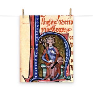 May include: A medieval illuminated manuscript page featuring a king sitting on a throne. The king is wearing a crown and a blue robe with a red cloak. He is holding a scepter in his right hand. The page is decorated with gold and blue lettering, including the text "Anglor Brito" and "Rex Legas".