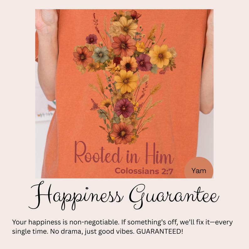 K&ouml;nnte beinhalten: Orangefarbenes T-Shirt mit floralem Kreuz-Design und dem Text "Rooted in Him" und "Colossians 2:7". Der Text "Happiness Guarantee" ist ebenfalls sichtbar.
