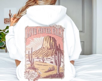 Sudadera con capucha "El amor nunca falla", sudadera cristiana occidental, suéter con versículo bíblico, regalo basado en la fe para ella, sudadera con capucha cómoda de Jesús para mujer