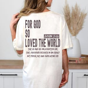 Christian oversized T-shirt displaying “For God So Loved The World,” making it a great scripture-based gift for women or men with strong faith.