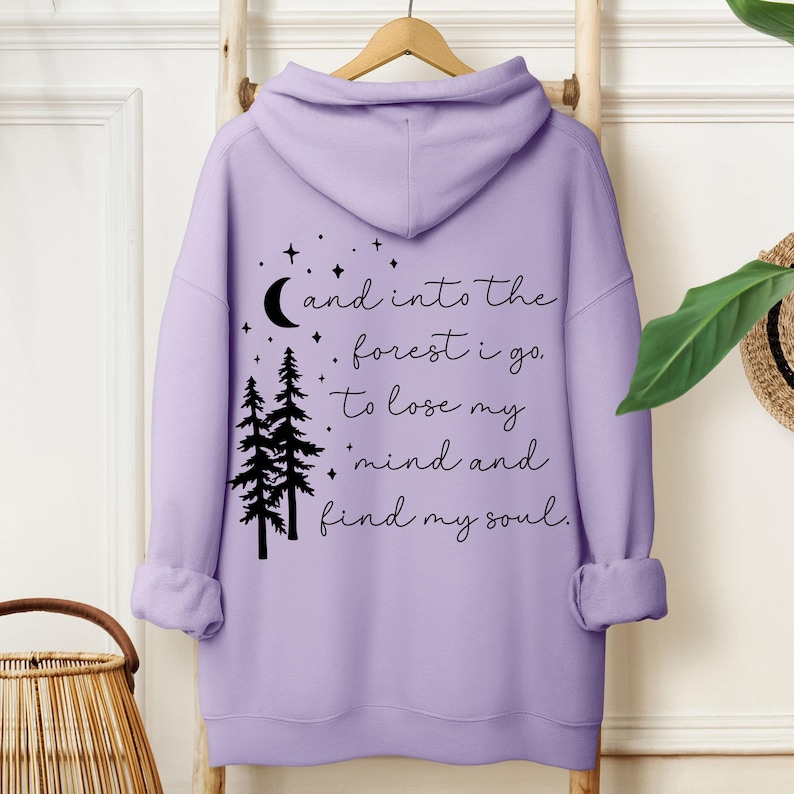 Cozy nature-inspired hoodie featuring a forest quote, perfect for hiking, camping, or outdoor adventures. A great gift for women who love inspirational clothing and nature-inspired designs with moon and star details.
