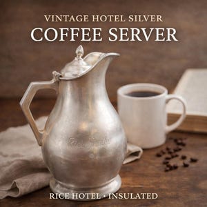 May include: Vintage silver coffee server with a lid and handle, next to a white mug filled with coffee. The server has the text "Rice Hotels" and the words "Vintage Hotel Silver Coffee Server" are at the top.