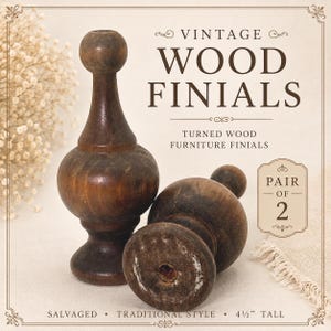 May include: A pair of dark brown turned wood finials with a rounded top and a bulbous base. The text on the image reads VINTAGE WOOD FINIALS, TURNED WOOD FURNITURE FINIALS, PAIR OF 2, SALVAGED, TRADITIONAL STYLE, and 4 1/2" TALL.