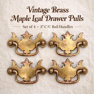 May include: Four vintage brass maple leaf drawer pulls. Each pull has a bail handle and is approximately 3 inches center to center. The text on the image reads "Vintage Brass Maple Leaf Drawer Pulls. Set of 4 - 3" C/C Bail Handles."