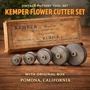 May include: Vintage Kemper Flower Cutter Set with original box. The set includes a variety of gray pottery tools. The box is brown with black text. The text on the box reads "Kemper Flower Cutter Set" and "Pomona, California."