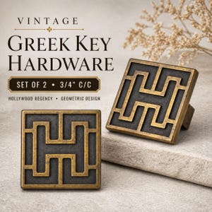 May include: Two vintage Greek key hardware pulls with a geometric design. The square pulls are bronze-colored with a dark gray recessed pattern. The text on the image reads "VINTAGE GREEK KEY HARDWARE SET OF 2 - 3/4" C/C HOLLYWOOD REGENCY - GEOMETRIC DESIGN."