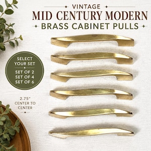 May include: Six brass cabinet pulls arranged vertically, each featuring a curved, elongated design. Text on the image reads: VINTAGE MID CENTURY MODERN BRASS CABINET PULLS, SELECT YOUR SET, SET OF 2, SET OF 4, SET OF 6, 2.75" CENTER TO CENTER.