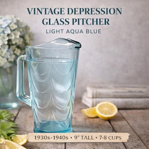 May include: A light aqua blue vintage Depression glass pitcher with a handle and a lid. The pitcher is 9 inches tall and holds 7-8 cups. The text on the image reads "VINTAGE DEPRESSION GLASS PITCHER LIGHT AQUA BLUE 1930s-1940s".