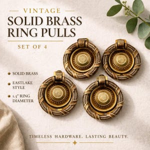 May include: Four vintage solid brass ring pulls in an Eastlake style. Each pull has a 1.5-inch diameter and features a detailed, circular design with a central medallion and a textured outer ring. The pulls are a warm, antique gold color.