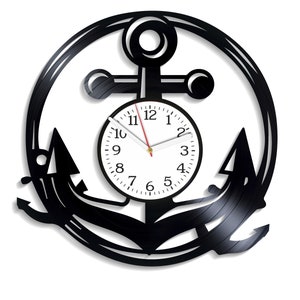 May include: Black vinyl record clock shaped like an anchor with a white clock face and black numbers. The clock hands are red and gold.