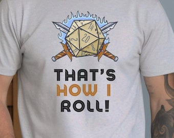 May include: A gray t-shirt with a graphic of a twenty-sided die with swords and flames. The text "That's How I Roll!" is printed below the graphic.